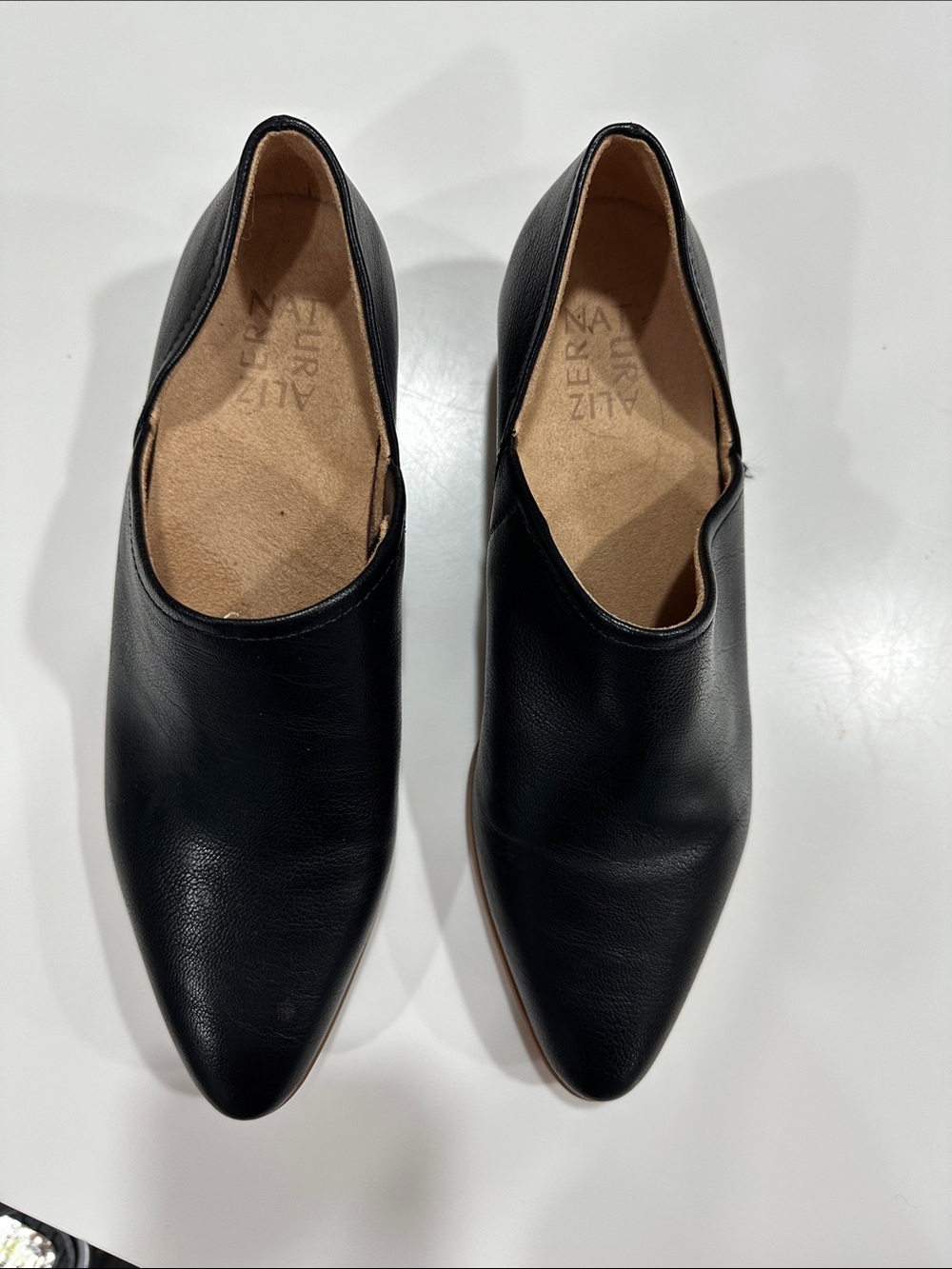 Naturalizer Carlyn slip-on shoes feature a sharp pointed toe.
